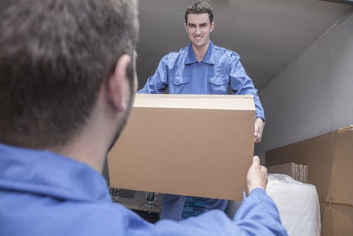 Removal team loading household items into a moving van