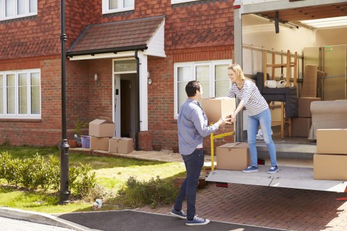 Professional furniture removals team handling a sofa in Brent