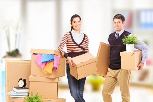 Moving crew preparing furniture for transport in Brent