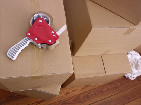 Prepared boxes and disassembled furniture ready for a Brent moving truck